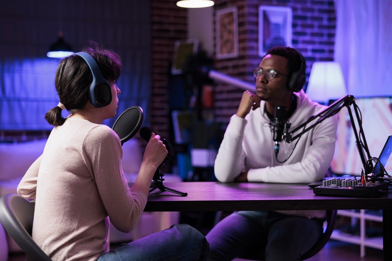 A man and a woman podcasting