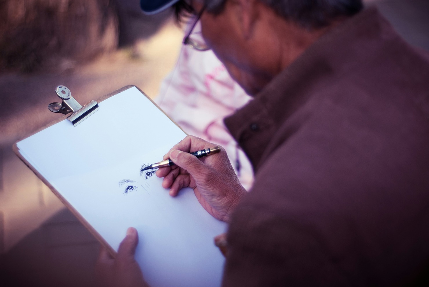 A man drawing a face.