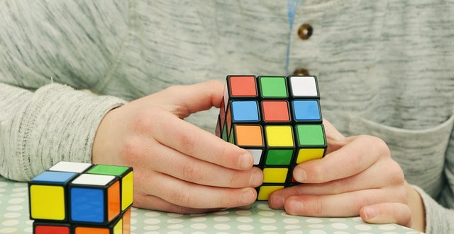 A man is solving rubic's cube