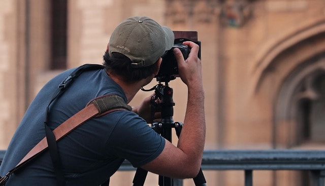 A man is taking photo of a building