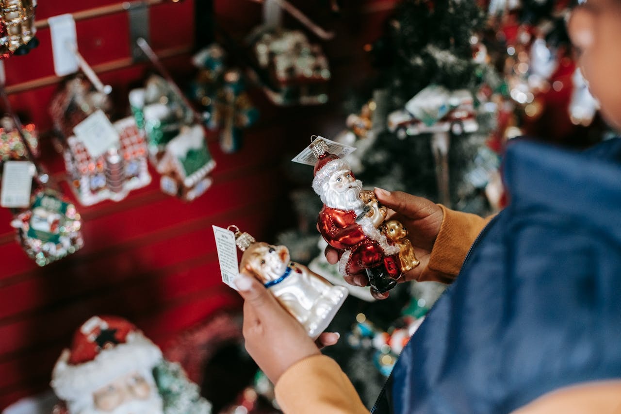 A person choosing christmas tree ornaments