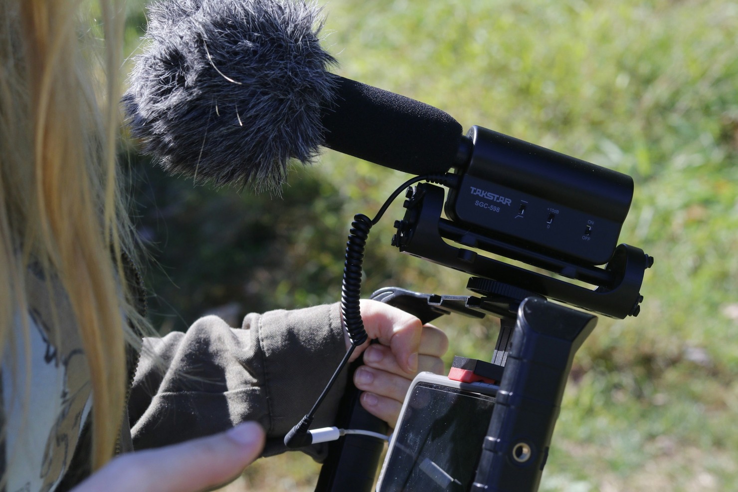 A person setting up a camera for vlogging.