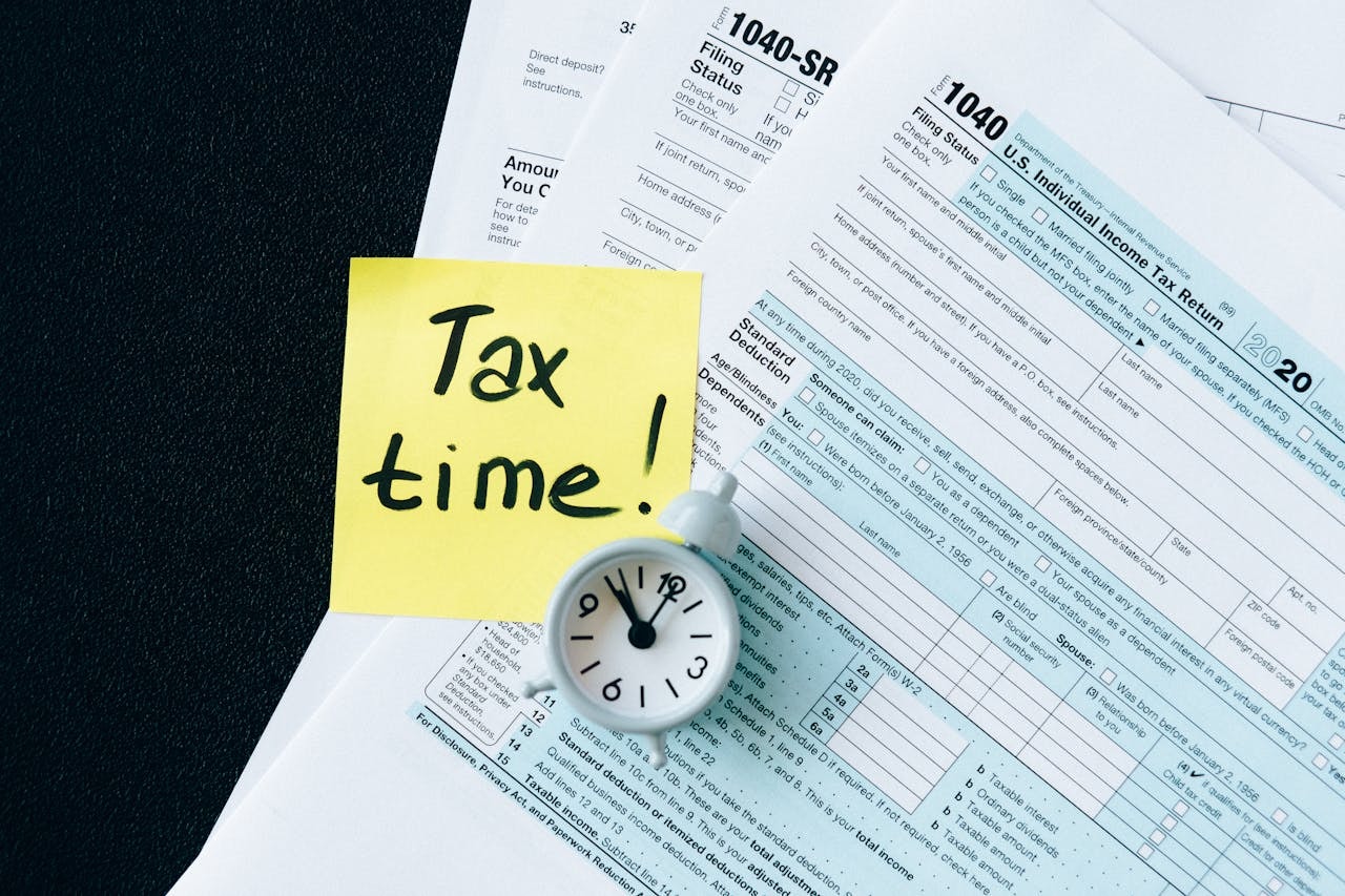 A photo of tax documents with Tax time written on a sticky note