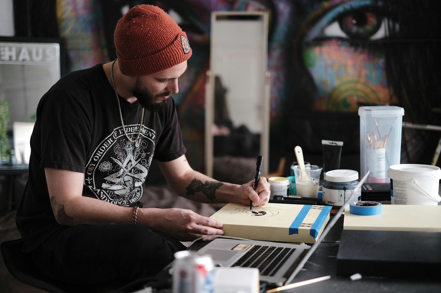 An artist drawing on a book.