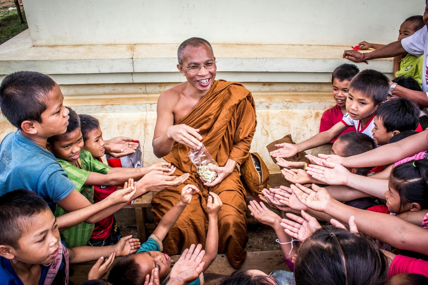 Man in Monk Dress with a Group of Children.