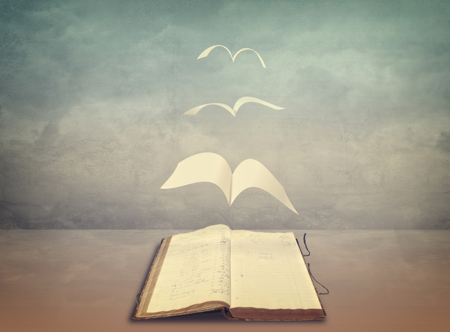 Papers flying from an old book.