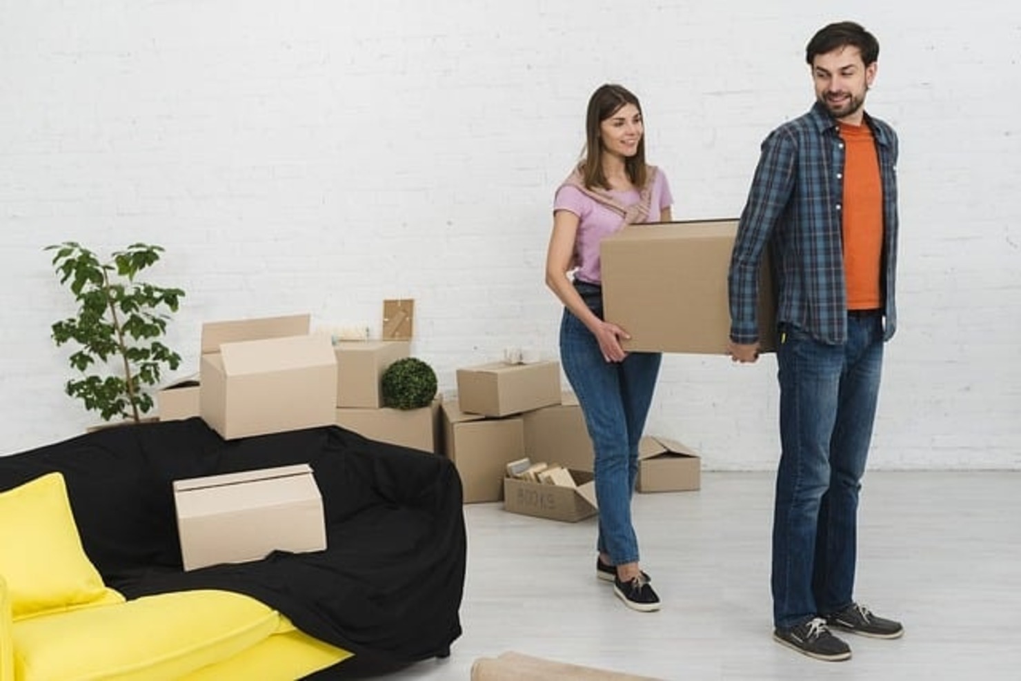 Two people carrying a box