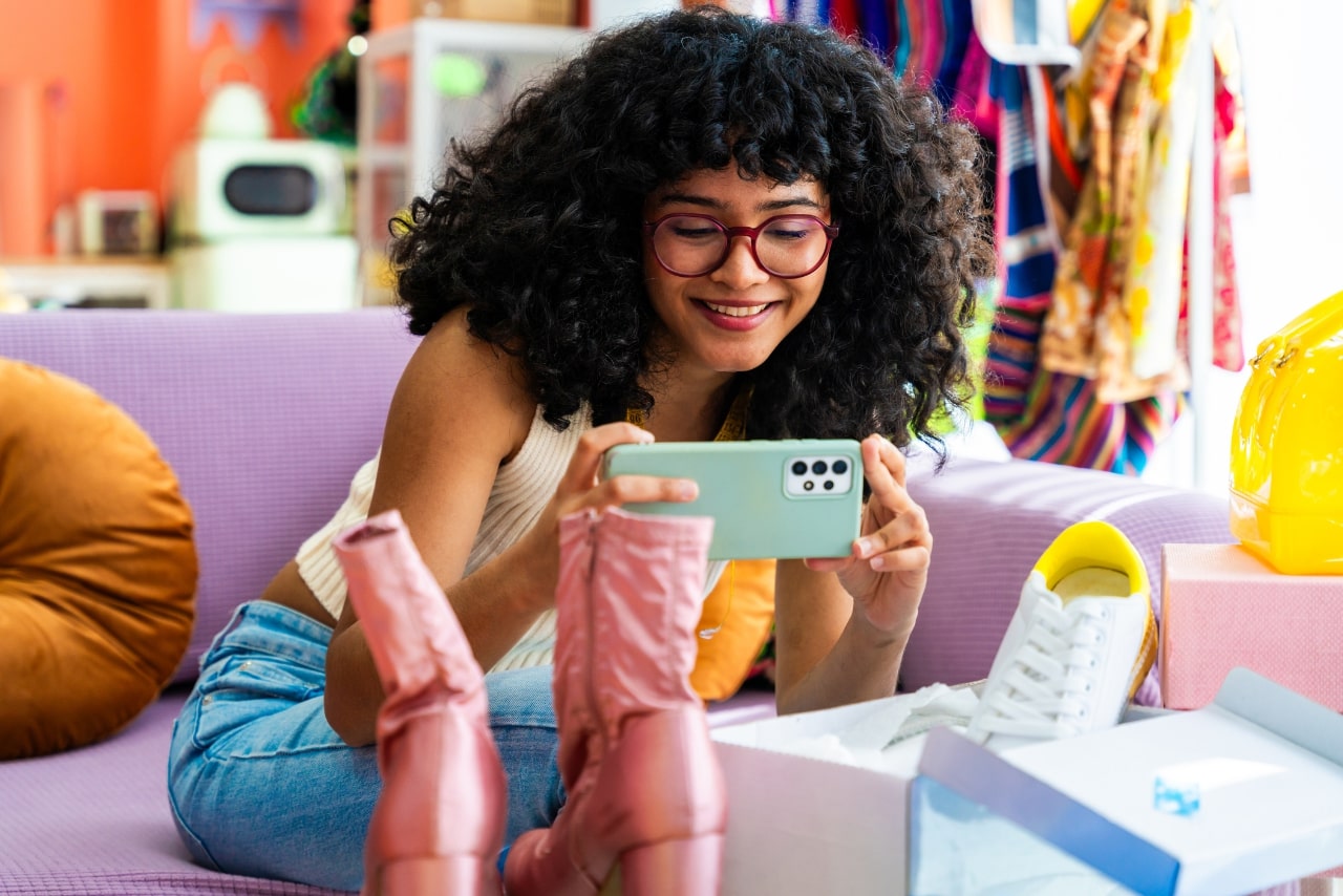 Young woman taking pictures of her store bought shoes.