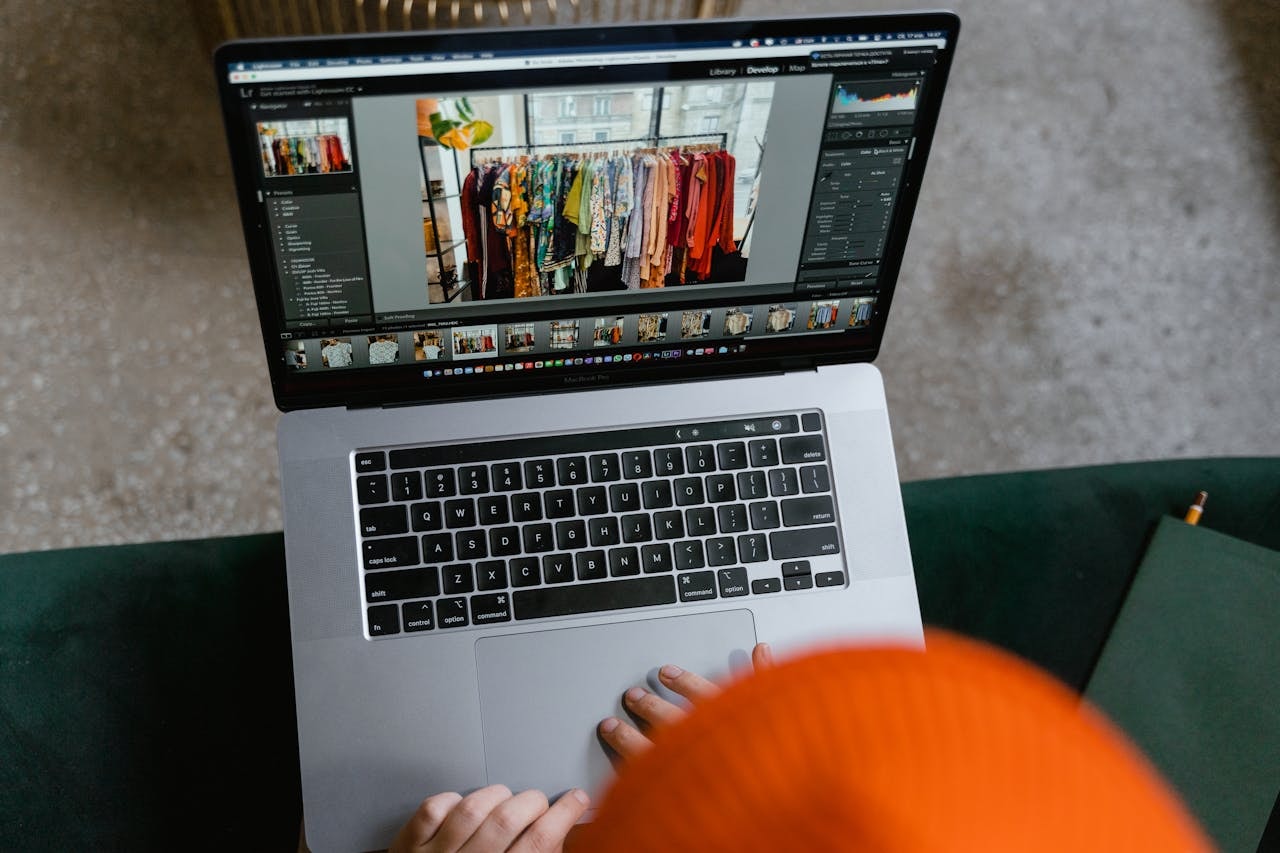 A laptop screen showing a photo of clothes in a display rack
