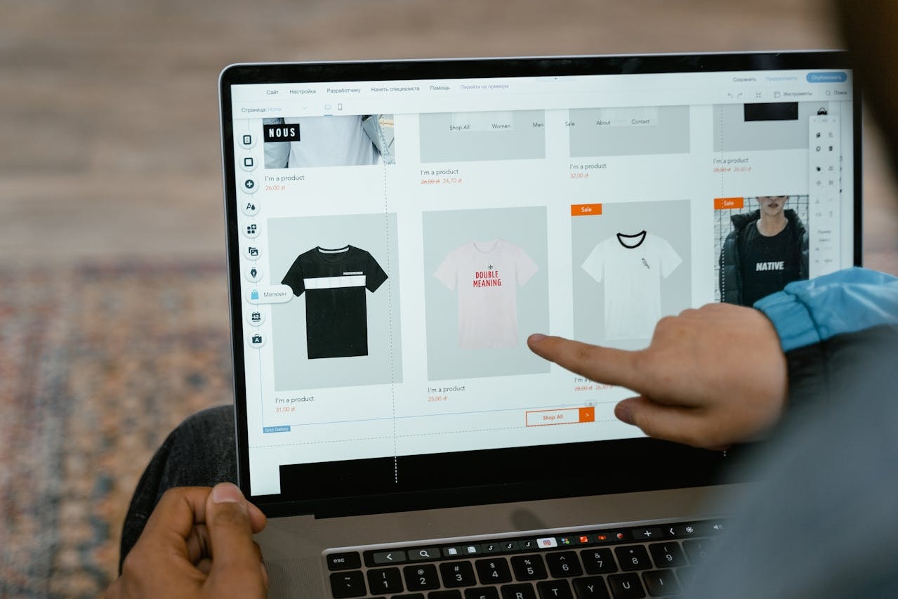 A laptop screen showing a website selling shirts