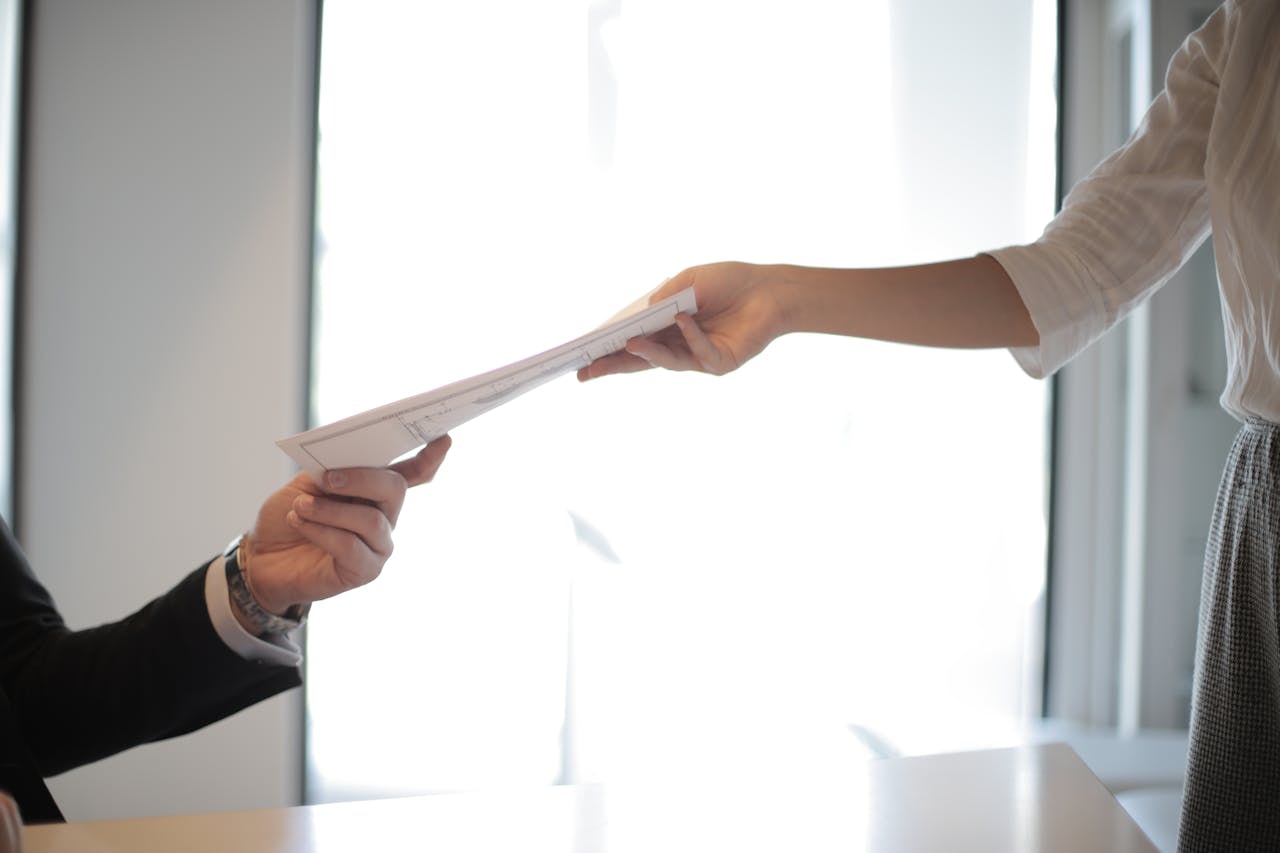 A man and woman holding a document