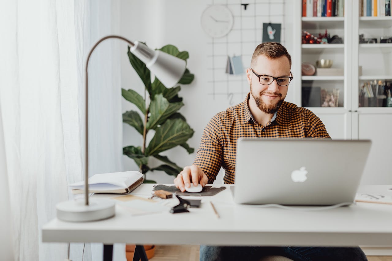 A man in his workstation using a laptop