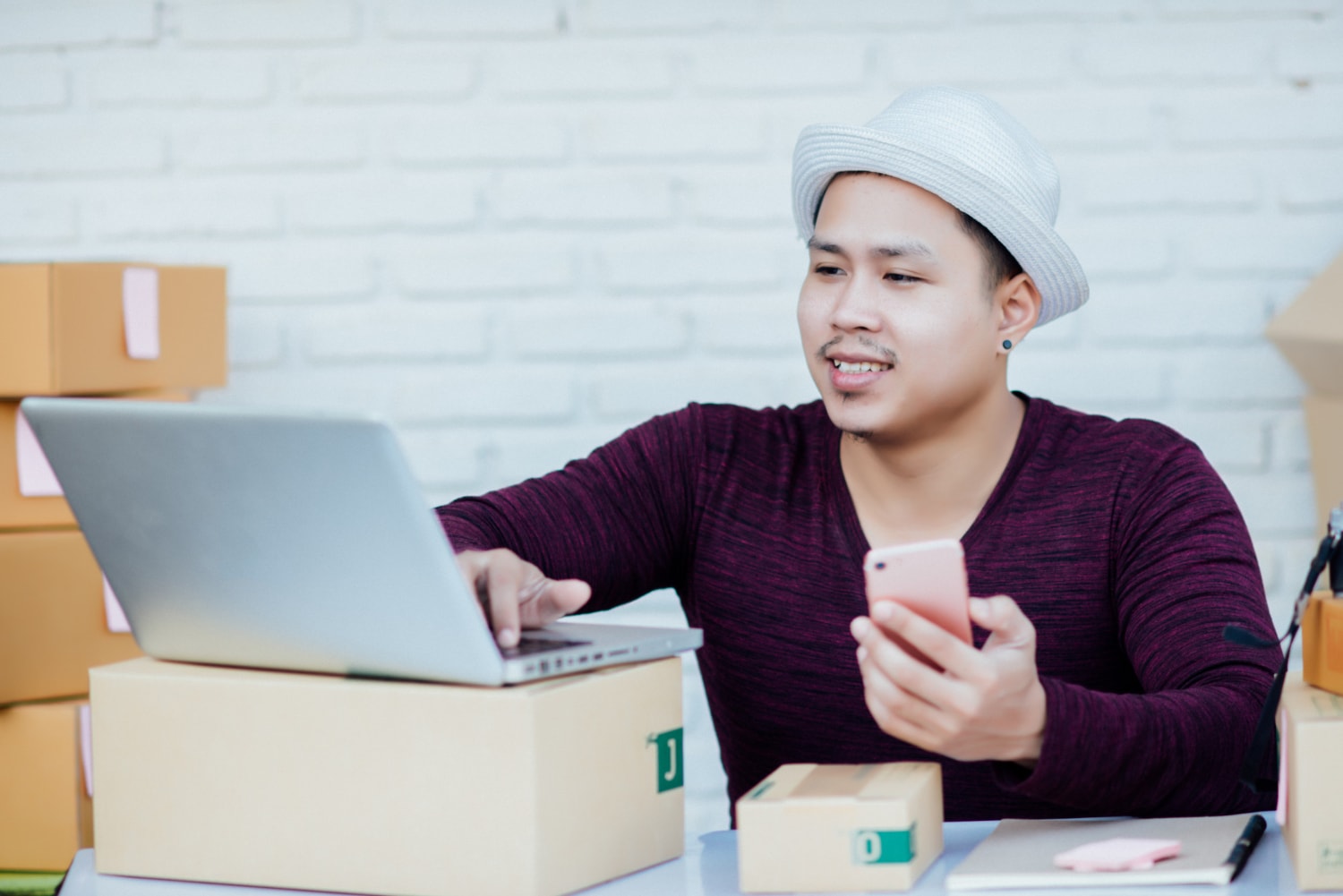 A man is conducting product testing in front of a laptop
