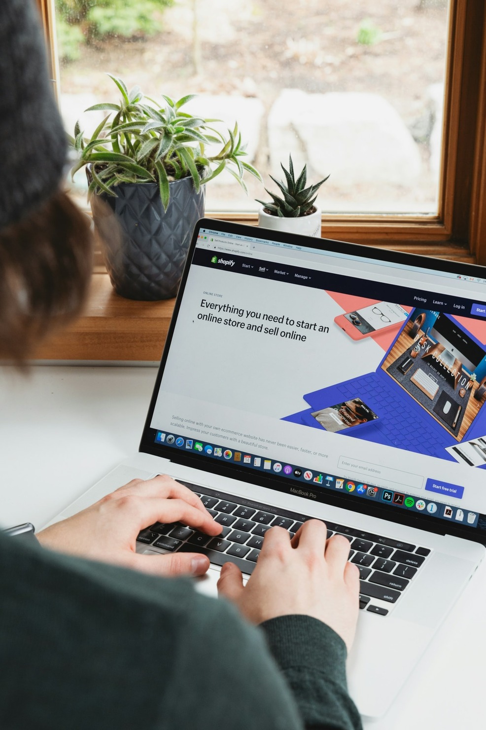 A person browsing the Shopify website on a laptop