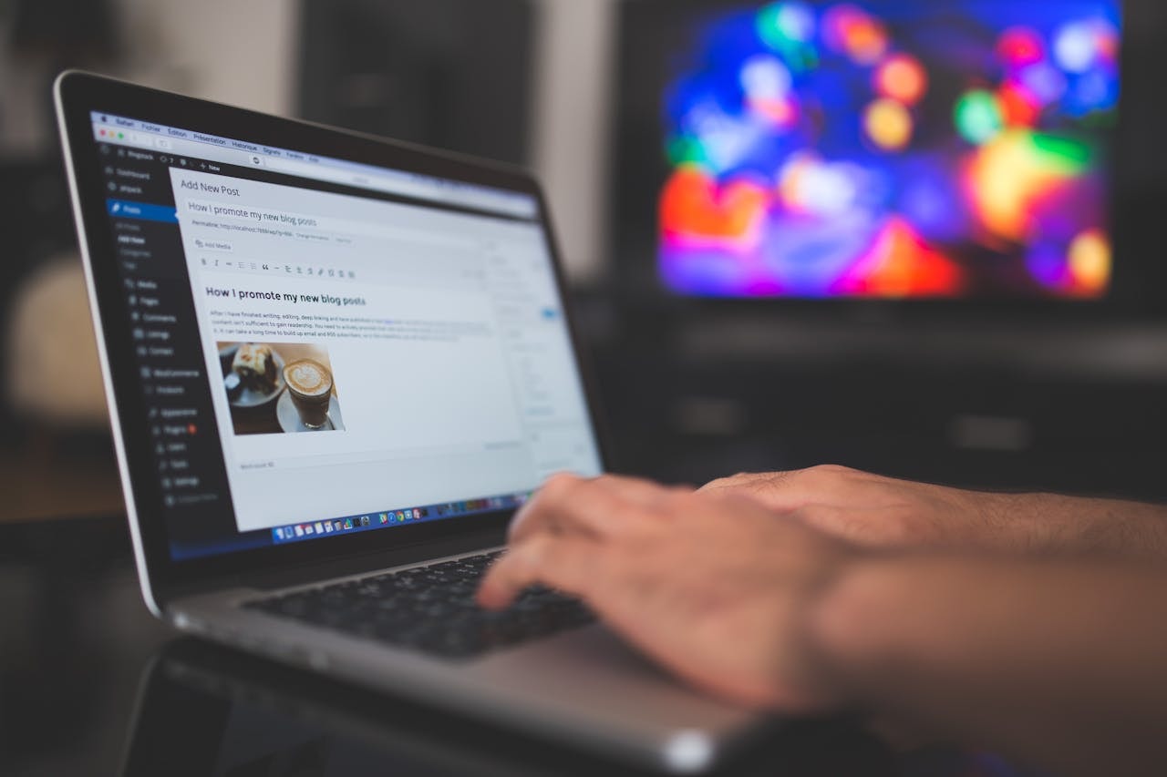 A person creating a blog post on a laptop