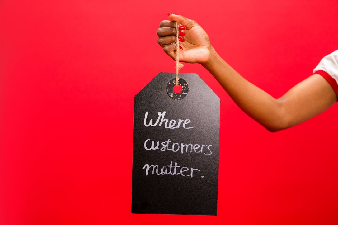 A person holding a sign that reads Where customers matter.