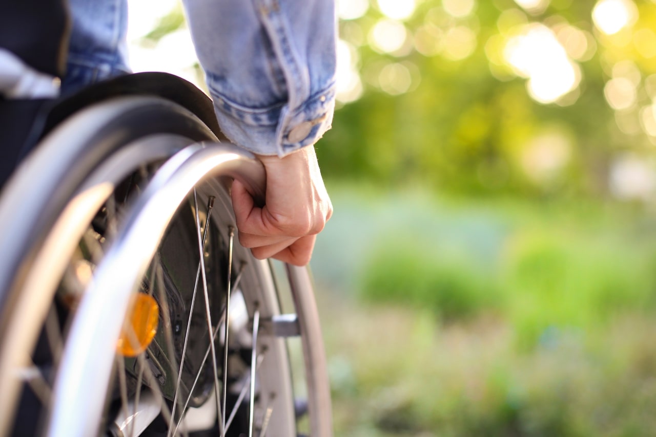 A person on a wheelchair at a park.