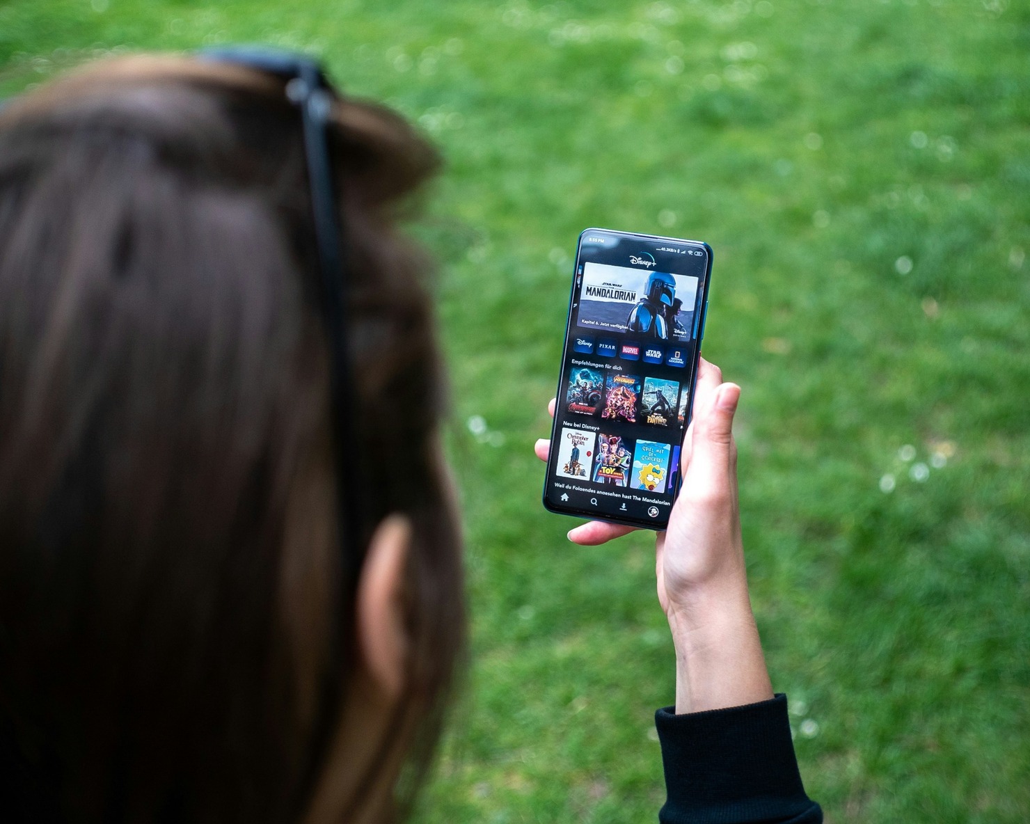 A person watching videos on her phone.