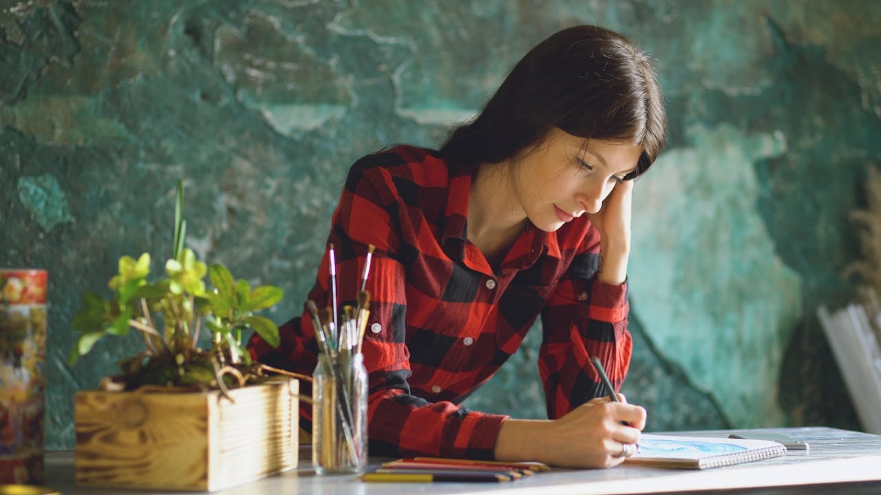 A photo of a woman sketching