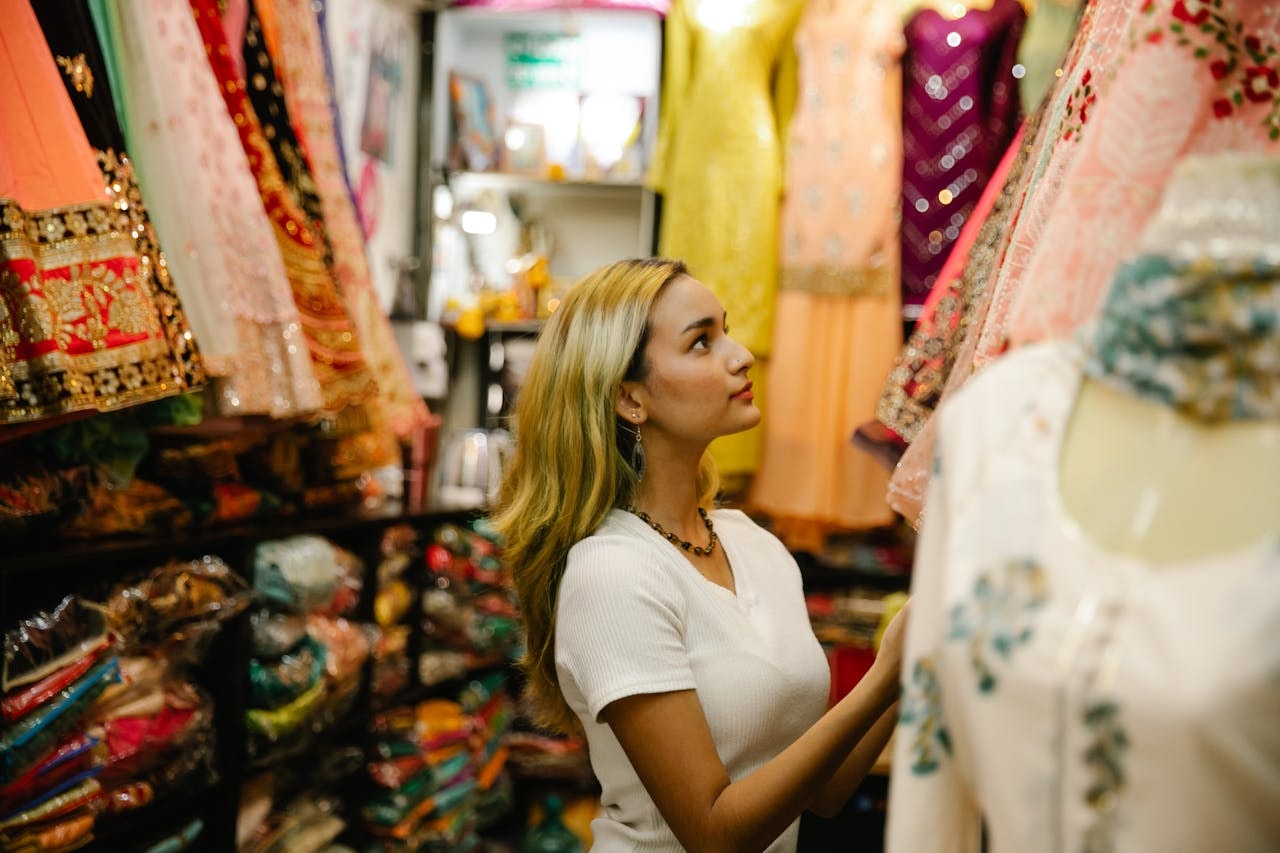A woman at a store looking at dresses