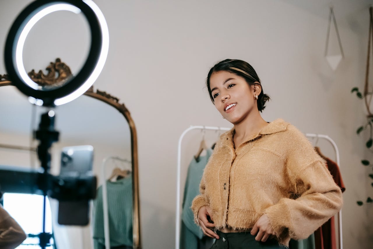 A woman influencer wearing a brown long-sleeve blouse