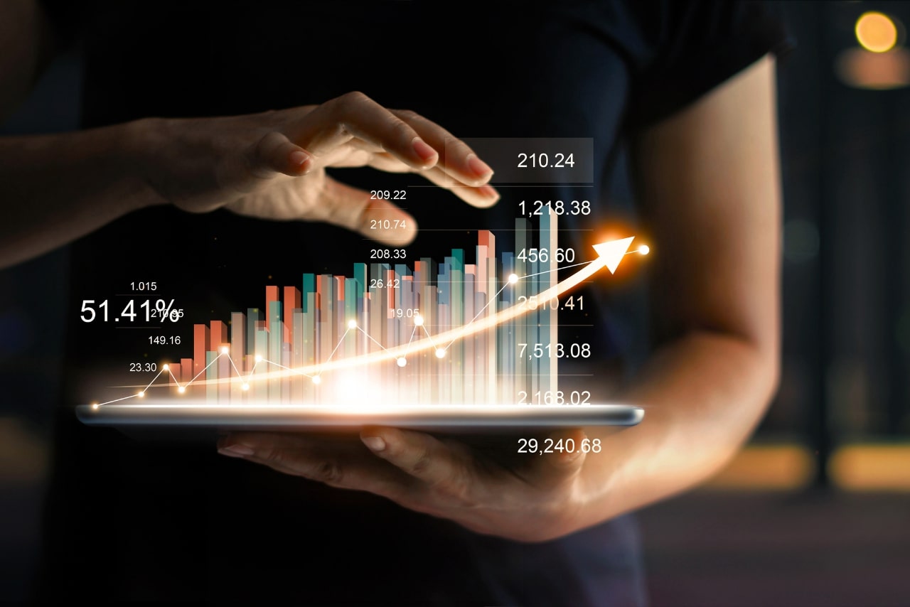 Businessman holding tablet and showing a growing virtual hologram of statistics.