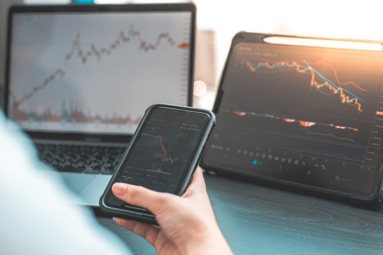 Checking stocks on phone, tablet and laptop.