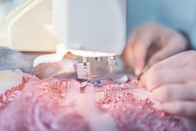 Close-up image of hands using a sewing maching.