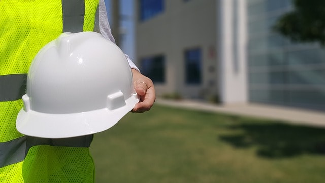 Construction worker wearing hardhat as safety gear.