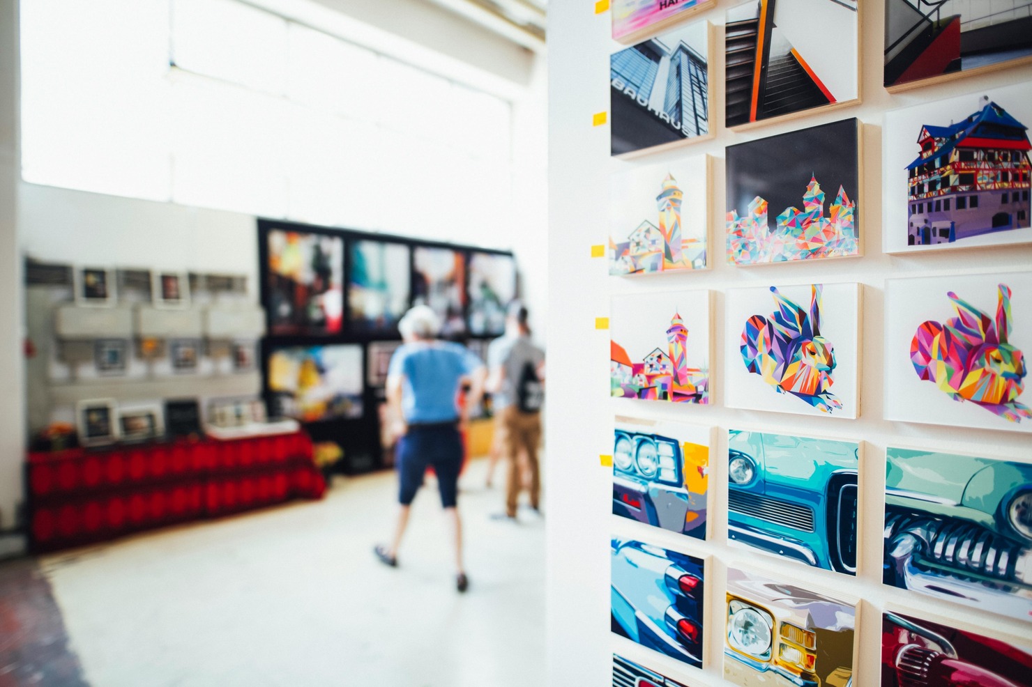 Display of mini paintings on a wall.