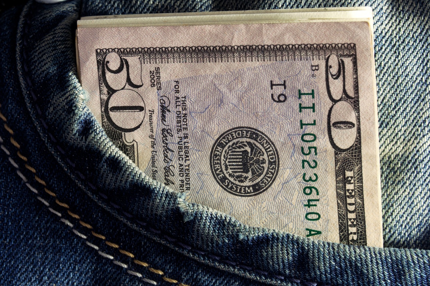 Dollars in a jeans pocket.