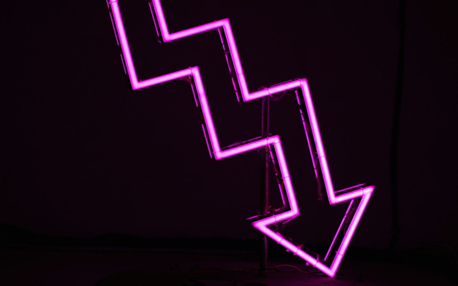 Downward facing arrow.