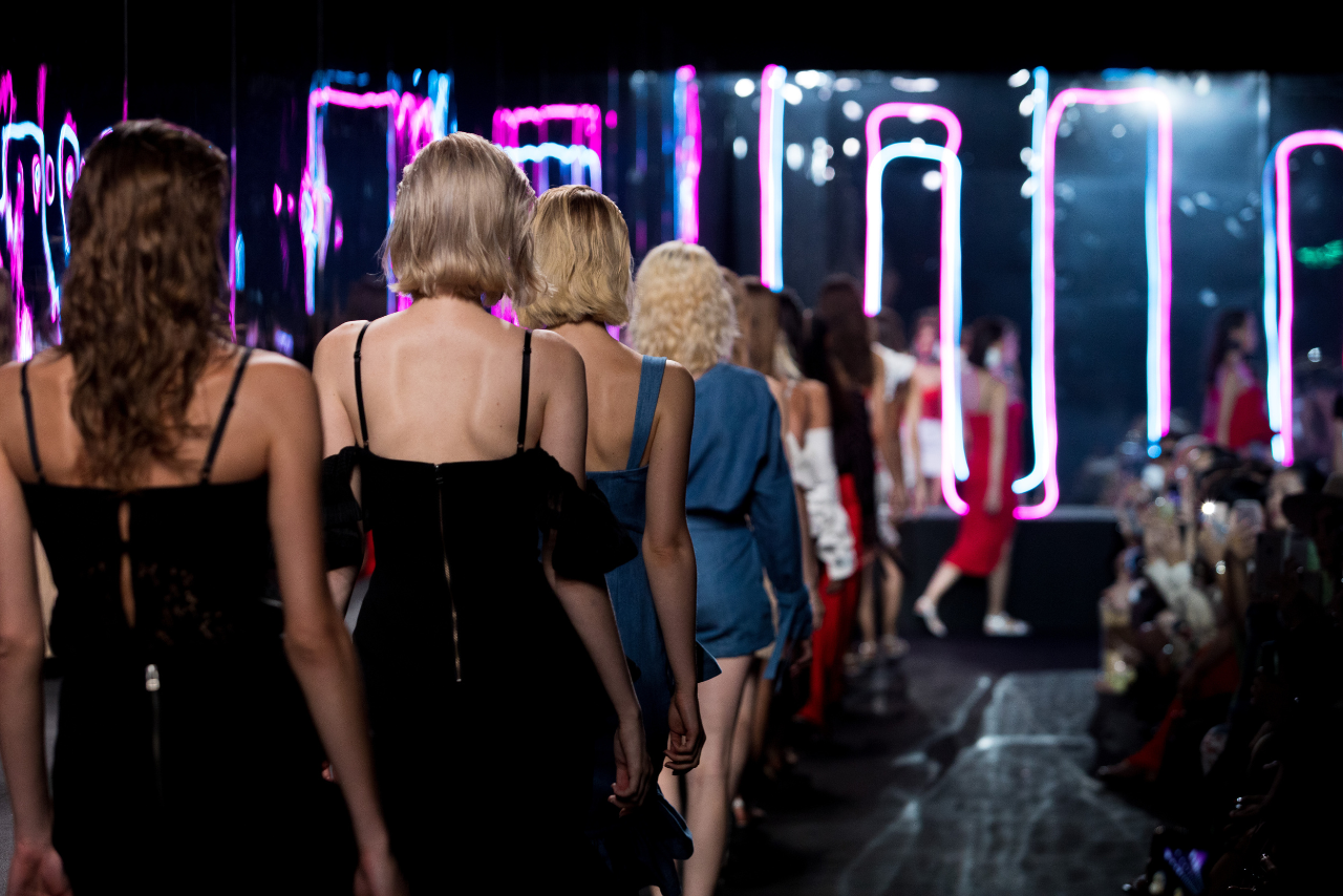 Fashion Models walk back Finale on Runway ramp.