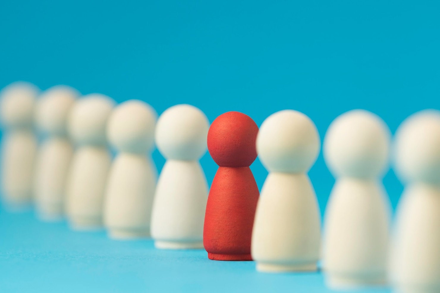 Focused red pawn surrounded by white ones.