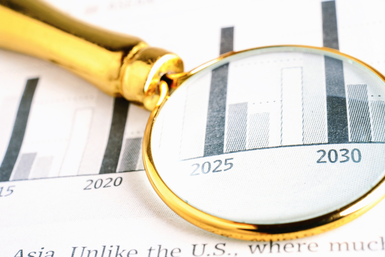 Future financial projection concept with magnifying glass on top of paper.