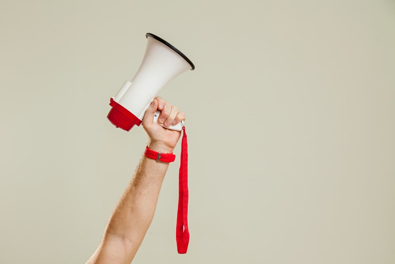 Loudspeaker being held upwards.