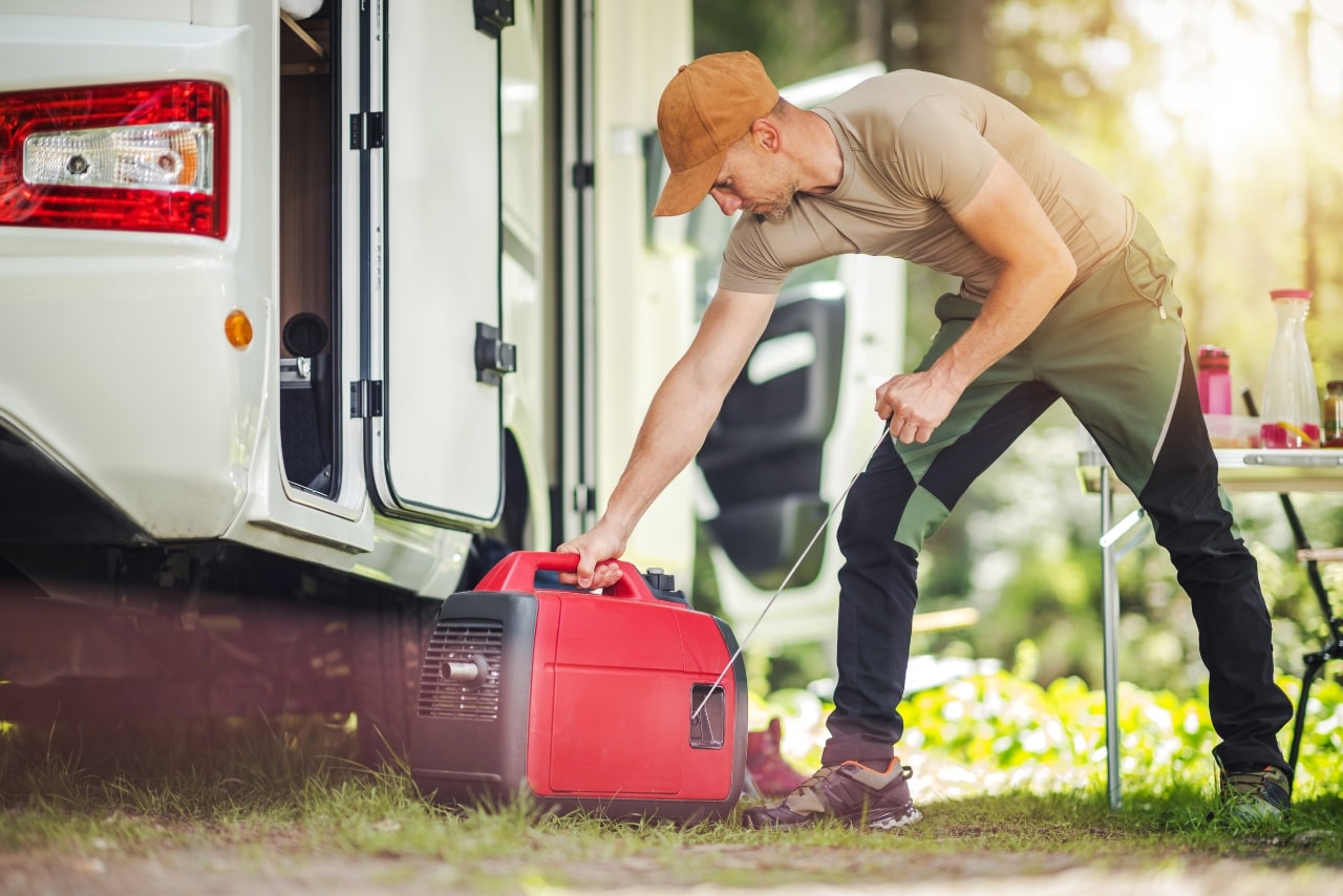 Man firing portable generator while setting up food truck.