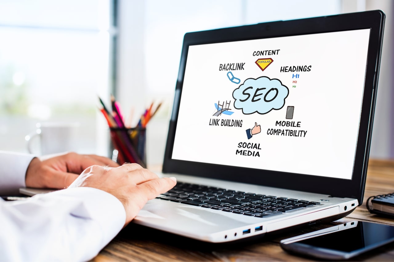 Man on laptop creating infographics about SEO.