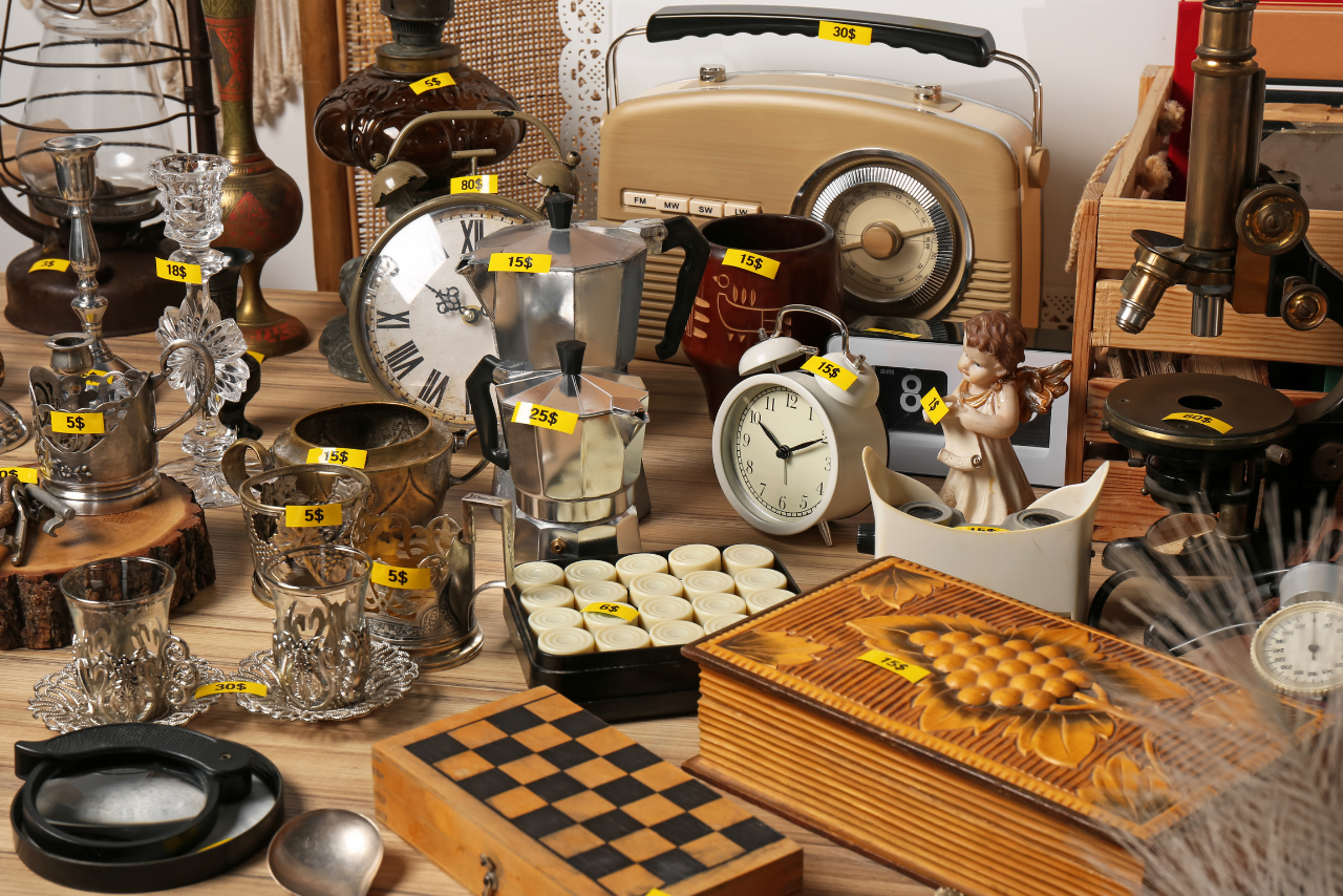 Many Different Items on Wooden Table with prices.