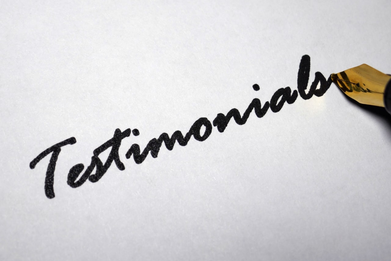 Pen writing Testimonials on paper.