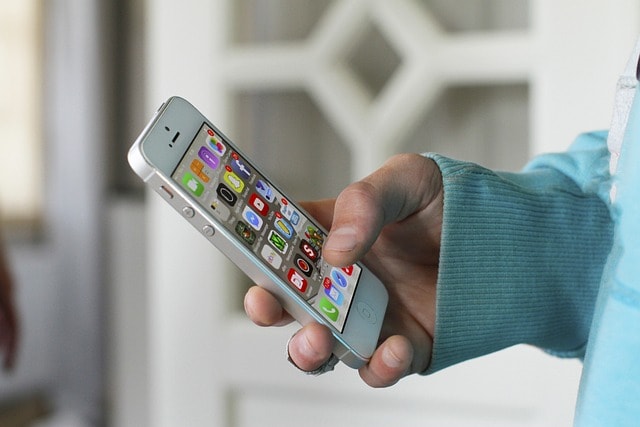 Person using iphone with one hand.