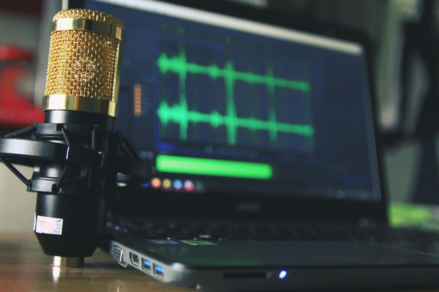 Podcast setup with a microphone and laptop.