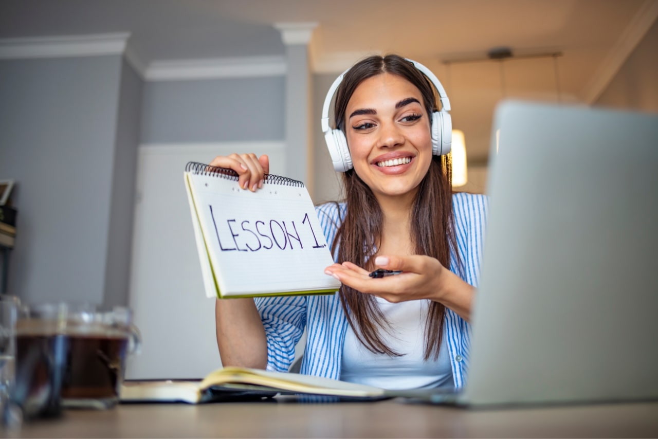 Professional female tutor giving online language classes.