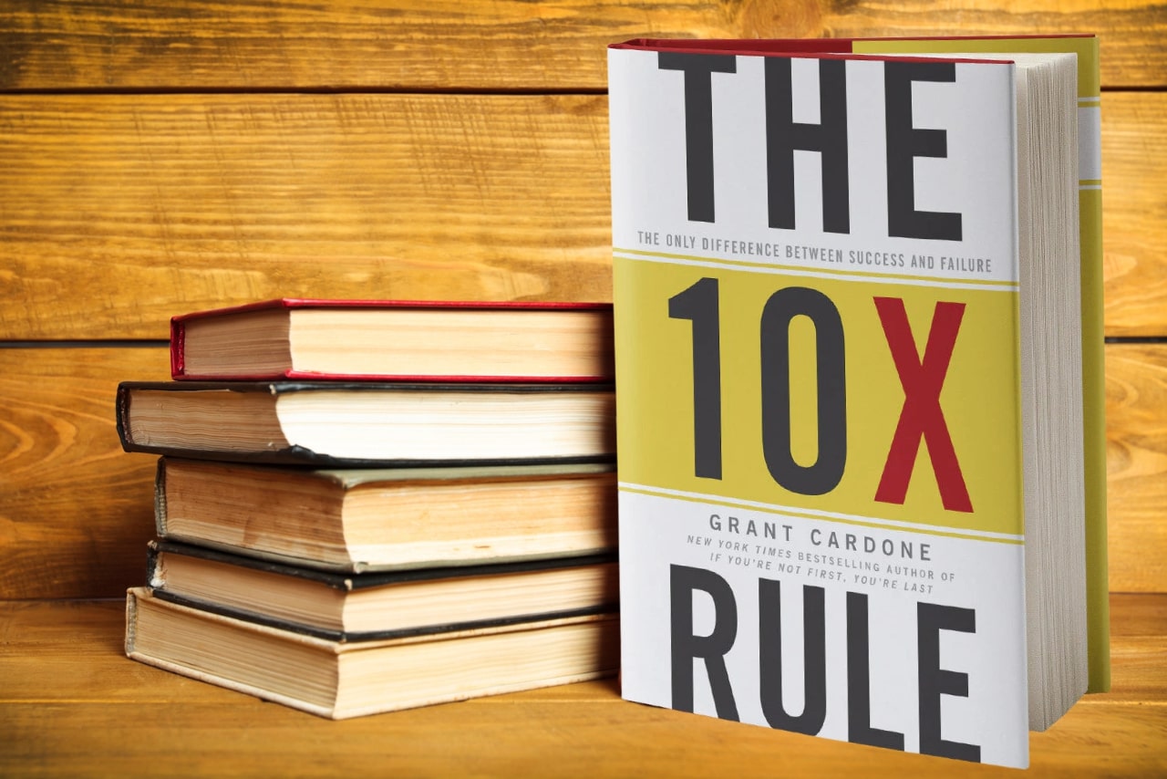 The 10x rule book besides other old books.