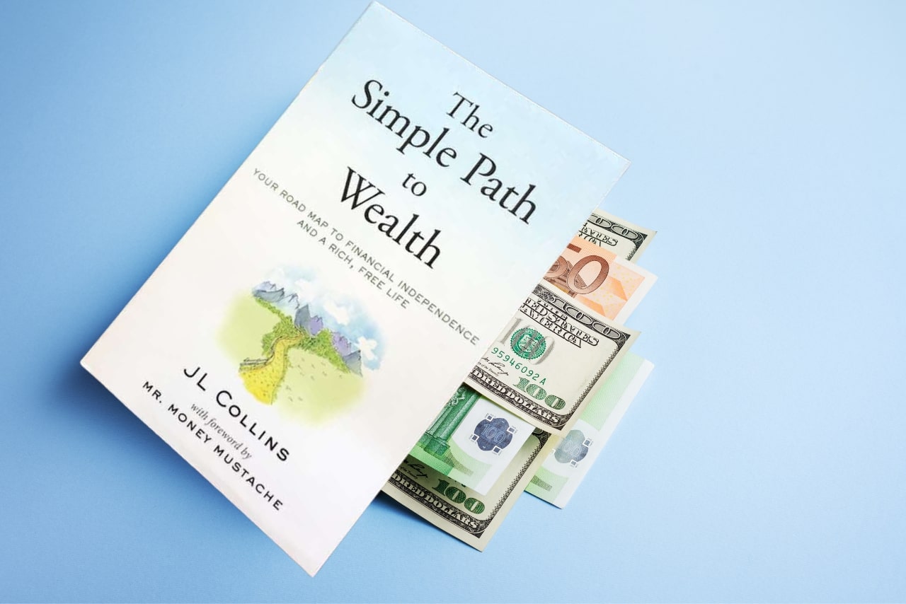 The Simple Path to Wealth book with money in between pages.