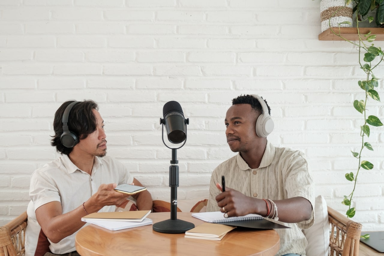 Two male podcasters talking to each other.