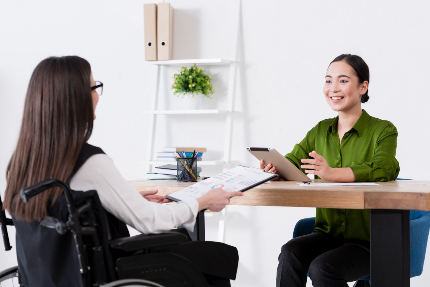 Two women are having a discussion with each other.