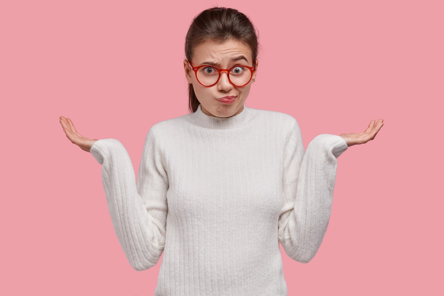 Unimpressed clueless woman spreads hands, feels hesitant, makes decision in mind.