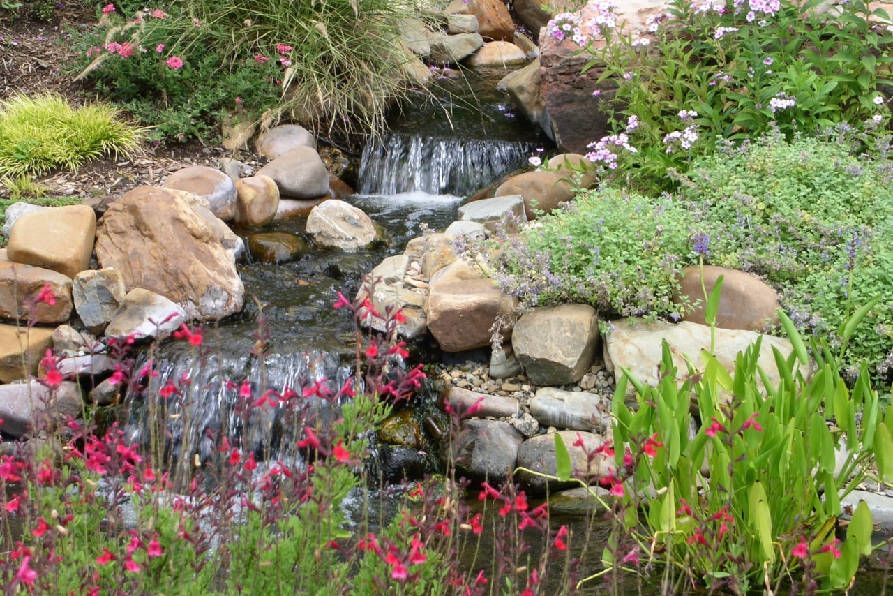 Waterfall with landscape and hardscape.