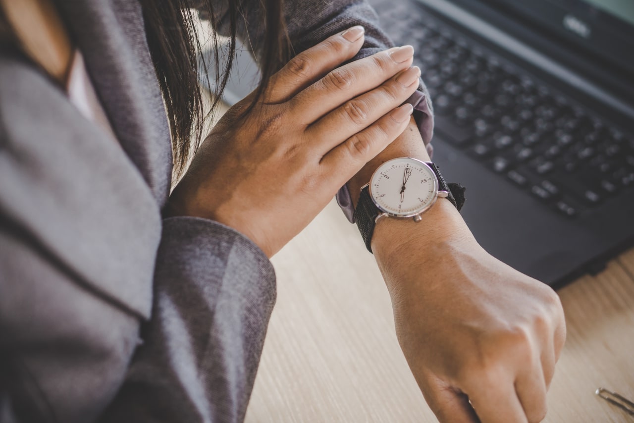 Woman Looking at Wristwatch.